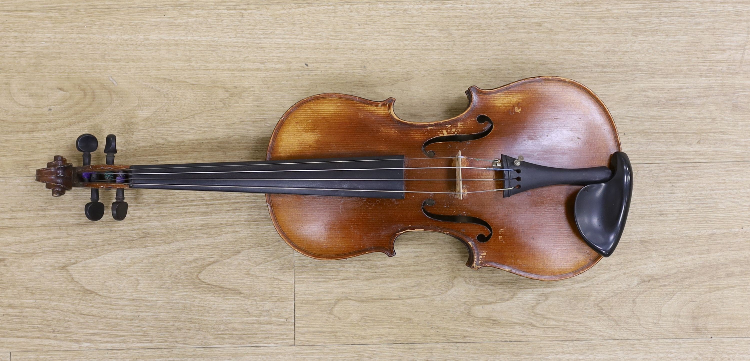 A cased violin, with bow